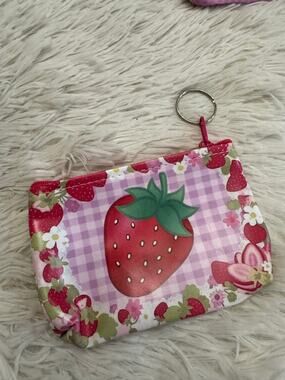 Strawberry keychain coin purse with large strawberry on a checkered background
